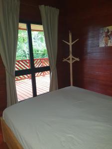 a bedroom with a bed with a cross on the wall at Casa do Príncipe in Santo António