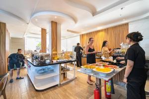 a group of people in a kitchen preparing food at The Solith Hotel Managed By Nicecy in Ho Chi Minh City