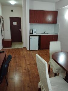 a kitchen and dining room with a table and chairs at ХОТЕЛ РАДНЕВО in Radnevo
