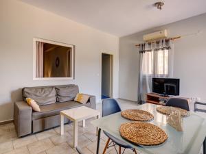 a living room with a couch and a table at Casa Fabrica in Ano Syros