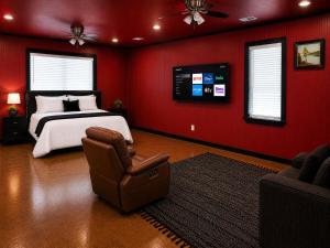 a bedroom with a bed and a chair and a tv at Toad-Ally Cozy Cottage - Conway Getaway in Conway