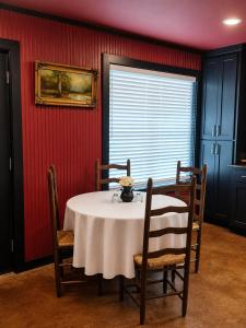 a dining room with a table and chairs and a window at Toad-Ally Cozy Cottage - Conway Getaway in Conway