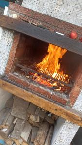a fire pit sitting on the ground with flames at Casa Sheila in Mahmudia
