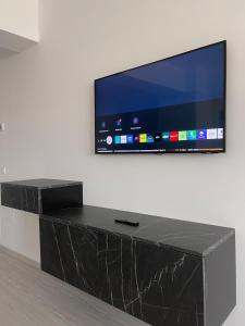a flat screen tv hanging on a wall at Soho Studio Fial in Bacău
