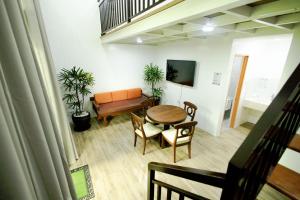 a living room with a table and a couch at The Stables by L' Rancho Danilo in Banaba