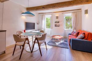 a living room with a table and a couch at Apt Libelule in Tourrettes-sur-Loup