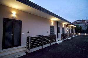 a row of shutters on a building at night at PAMA Home in Acerra