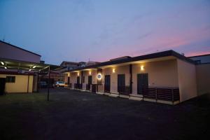 a row of buildings in a parking lot at night at PAMA Home in Acerra