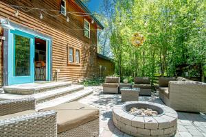 a patio with chairs and a fire pit next to a house at Red Elephant | 4BR - Fire Pit - River & Downtown in Hailey