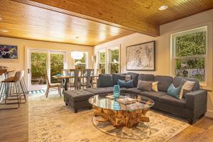 a living room with a couch and a table at Red Elephant | 4BR - Fire Pit - River & Downtown in Hailey