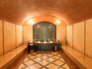 a large room with a bath tub in a building at Le Diwan Hotel Rabat - MGallery Collection in Rabat