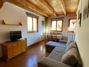 a living room with a couch and a tv at Camping Aneto in Benasque