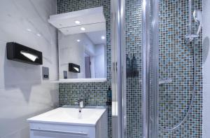 a bathroom with a sink and a shower at Best Western Victoria Palace in London