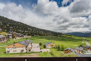 a small town in a green field with houses at L'Elan in Les Angles