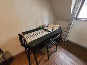 a black piano with a table with dishes on it at La Chambre Claire in Strasbourg