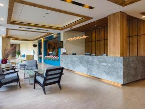 an office lobby with a reception desk and chairs at Golden Tulip Essential Belitung in Tanjungpandan