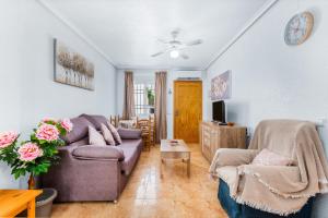 a living room with a couch and a table at Villa Patrick in Torrevieja