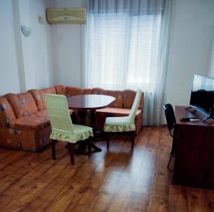 a living room with a couch and a table and chairs at ХОТЕЛ РАДНЕВО in Radnevo +9 photos