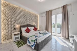 a bedroom with a bed and a large window at Sara Venice station in Mestre