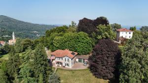 an aerial view of a house in the trees at L'Elefante Fritz Boutique Lodge - Villa Piazzo in Pettinengo