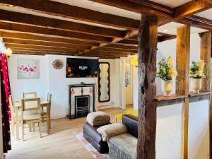 a living room with a couch and a fireplace at sinton House in Bransford