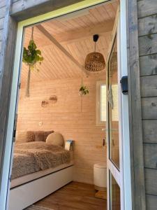 a bedroom in a tiny house with a bed at Tinyhouse Cecilka in Ústí nad Orlicí