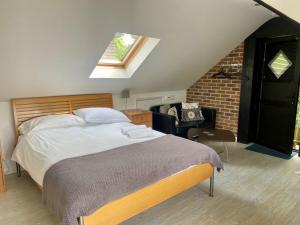a bedroom with a large bed in a attic at Hunters Hide Apt in Littlehampton