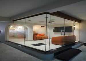 a large glass room with a bed in it at TheCloud Hotel in Nizāmābād