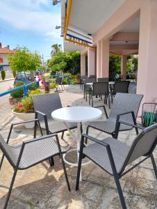 a group of chairs and tables on a patio at Hotel Eleni in Paralia Dionysiou
