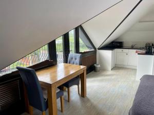 a dining room with a table and some chairs at Hunters Hide Apt in Littlehampton