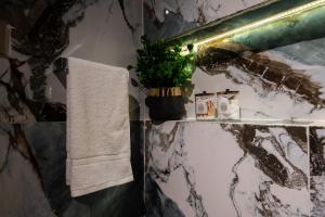 a bathroom with a towel and a plant on a counter at Secret Garden Kalam in Kalām +122 photos