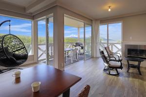 a living room with a table and chairs at Resort Villa Takayama in Takayama