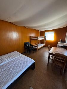 a bedroom with a bed and a wooden wall at Domki Letniskowe Vertigo Narie in Morąg +4 photos