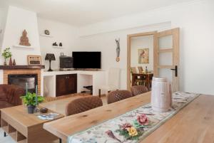 a living room with a wooden table and a fireplace at Casa Susana in Santa Eularia des Riu