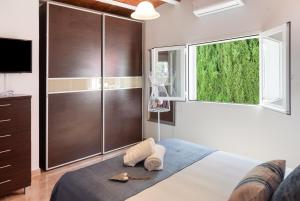 a bedroom with a bed and a large window at Casa Susana in Santa Eularia des Riu +31 photos