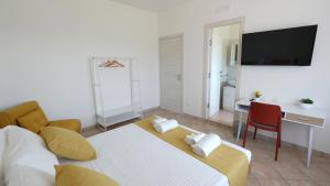 a bedroom with a bed and a desk and a television at Country House Altavilla in Altavilla Silentina +19 photos