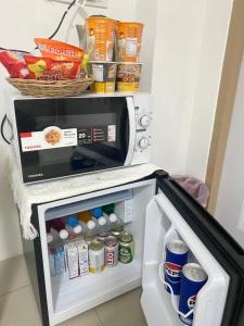 an open refrigerator with food inside of it at The Sunset Bangsaen in Ban Rong Khoei +29 photos