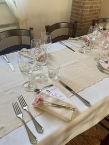 ein Tisch mit Weingläsern und Silberbesteck in der Unterkunft Origami in Magliano Alfieri