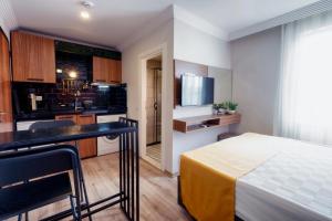 a hotel room with a bed and a kitchen at Terra Rossa in Antalya +30 photos