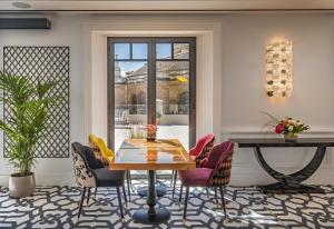a dining room with a table and chairs at Gran Hotel Claridge Granada - Preferred Hotels & Resorts in Granada
