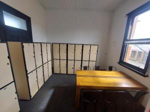 an empty room with a wooden table and a door at The Vine & Lamb in Saint Arnaud