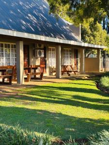 a house with a picnic table in the yard at Adem Gasteplaas & Function Venue in Kroondal