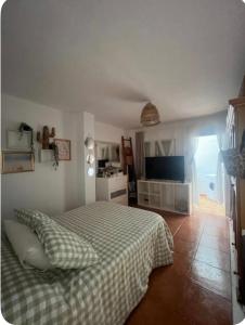 a bedroom with a bed with a checkered blanket at Villa guiris in Barbate