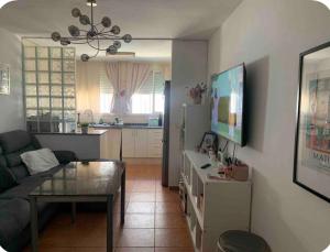 a living room with a couch and a table at Villa guiris in Barbate