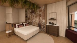 a bedroom with a large bed and a mirror at Van der Valk Hotel Maastricht-Maas in Maastricht