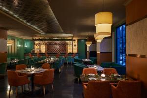 a restaurant with tables and chairs and a bar at JW Marriott Hotel Chandigarh in Chandīgarh