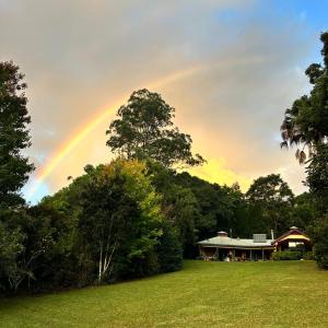 a rainbow in the sky over a house at Evermoore Homestead in Gleniffer +10 photos