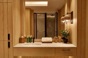 a bathroom with a sink and a mirror at 1 Hotel Mayfair in London +46 photos