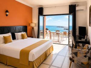 a bedroom with a bed and a view of the ocean at Hôtel Calipau Riad Maison d'Hôtes in Dakhla +94 photos
