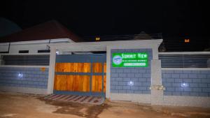 a small building with a sign in front of it at Summit View Retreat in Moshi +8 photos